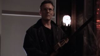 Giles with a chainsaw in Buffy