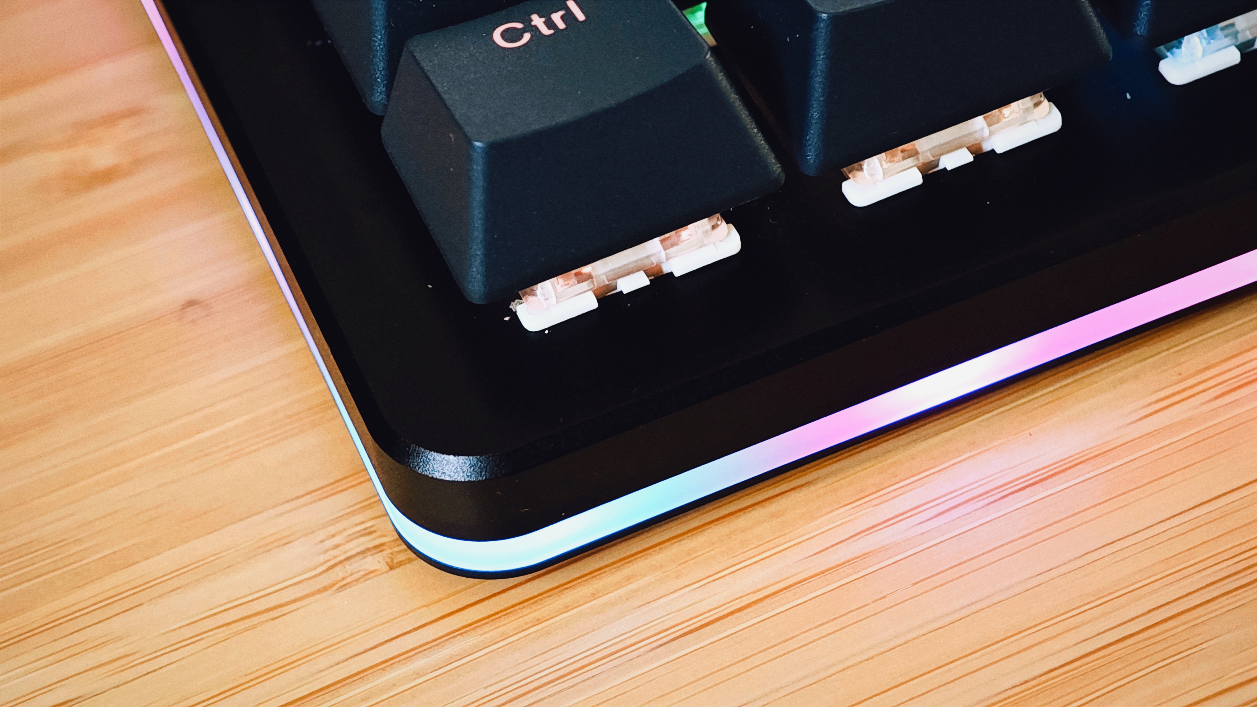 A black Drop CTRL V2 keyboard on a wooden desk