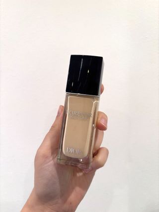 Mica Ricketts holding bottle of Dior Forever Skin Glow Foundation