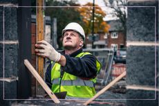 close up of a builder starting work on a house outside in the UK