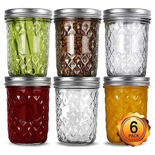 Six glass jars with silver lids filled with jams or fruit stack two high by three wide