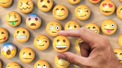 Choosing a happy face emoji from a pile of options.