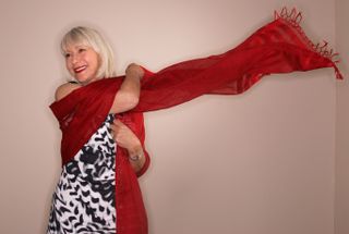 Helen Mirren poses with a red scarf in 2010