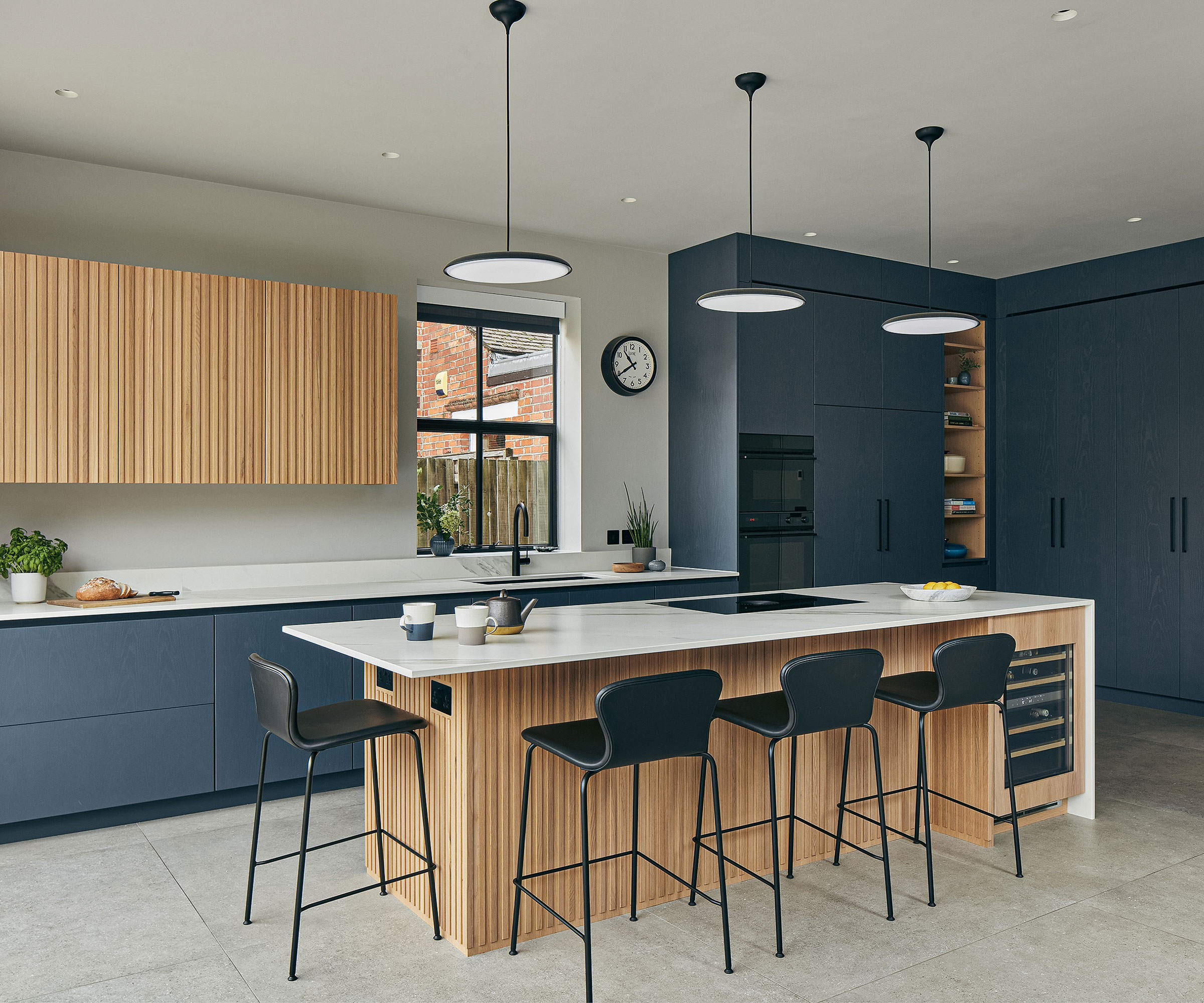 handle free blue kitchen with fluted wooden kitchen island