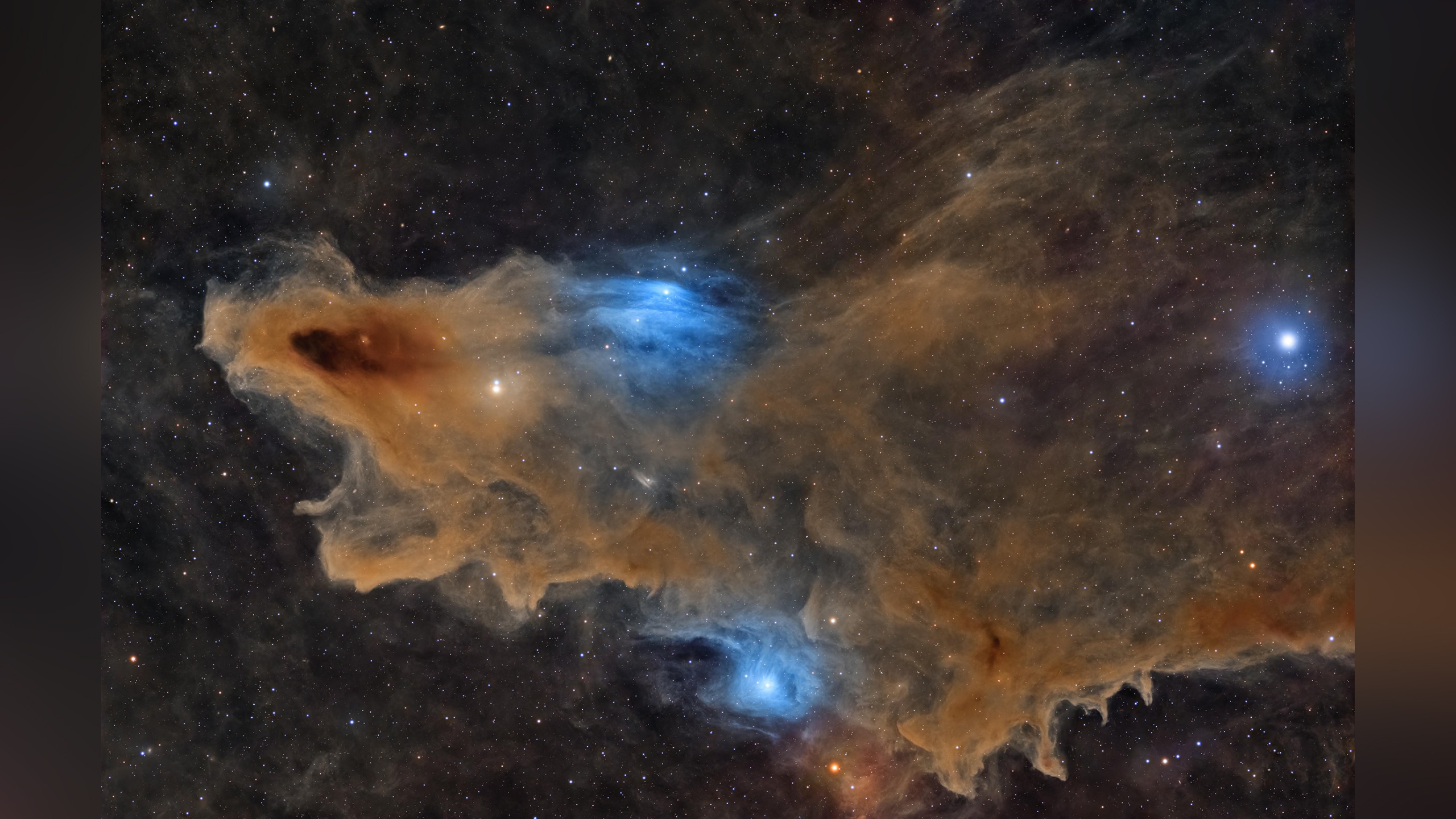 Colorful nebula with dense orange and blue gas clouds surrounding bright stars in deep space