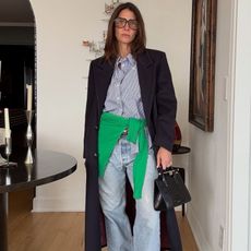 Jen Wonders wearing light-washed jeans with cinched loafers.