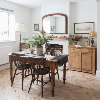 dinning room with mirror on wall and wooden dining table