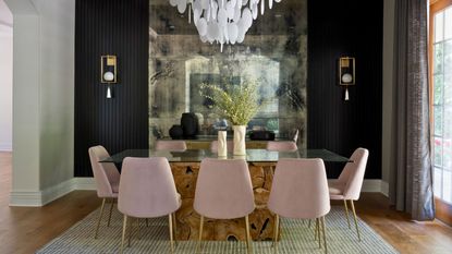 dark dining room with chandelier and mirror
