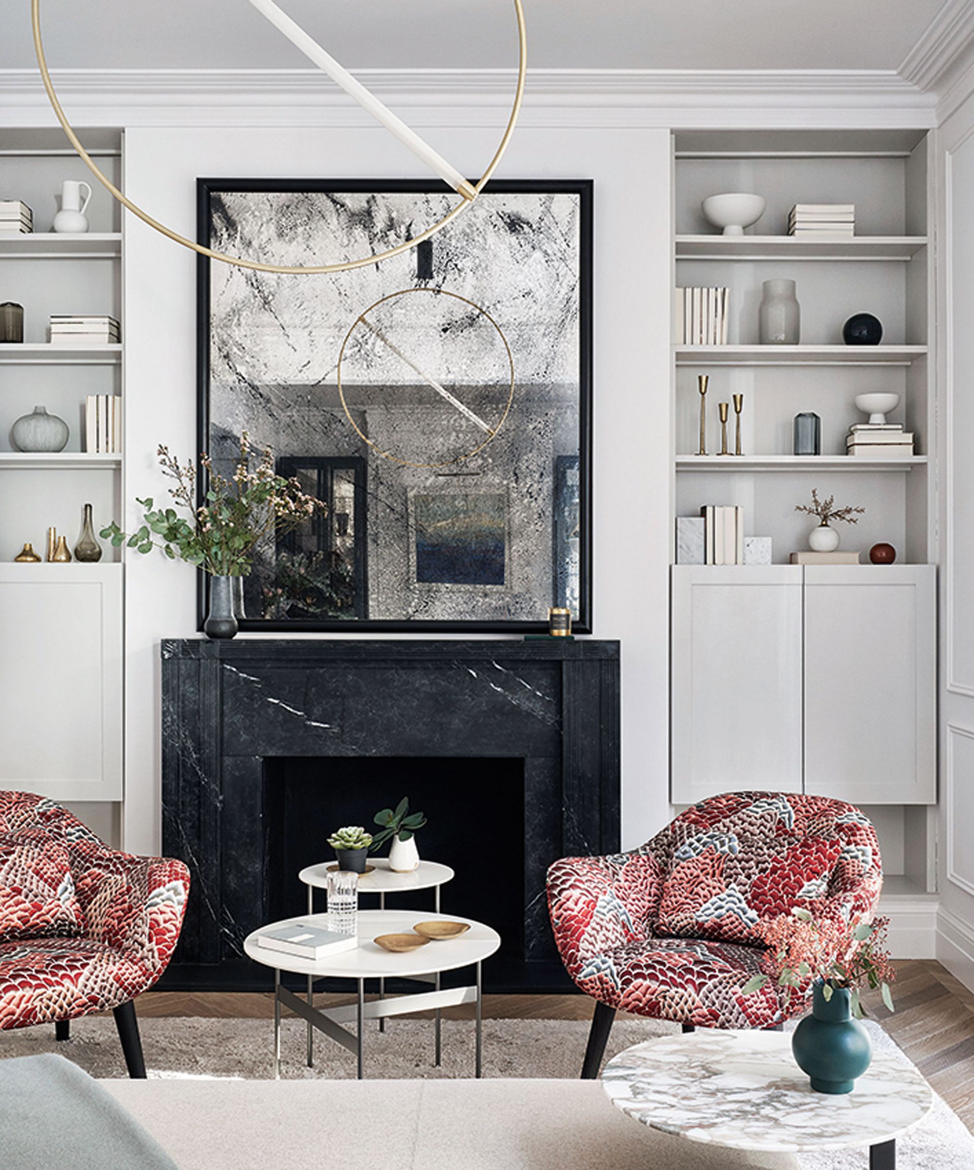 living room with fireplace, mirror and statement light