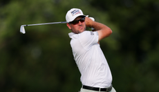 Corey Conners hits an iron shot