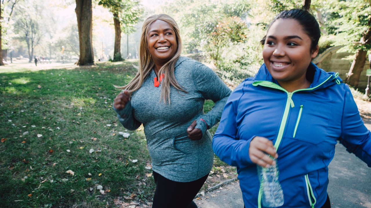 Two women running in a city