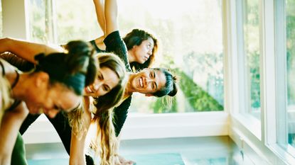 Group of women stretch together