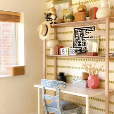 home office with wood shelving and vases on display