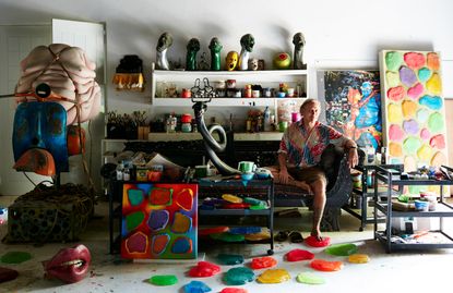 Ashley Bickerton in his studio in Bali, surrounded by sculptures and paintings
