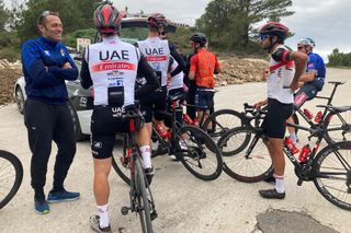 Team UAE Emirates riders with a team car