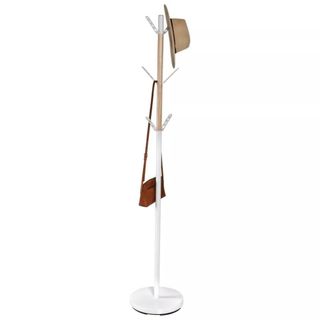 A white coat rack with a hat and a purse hanging from it