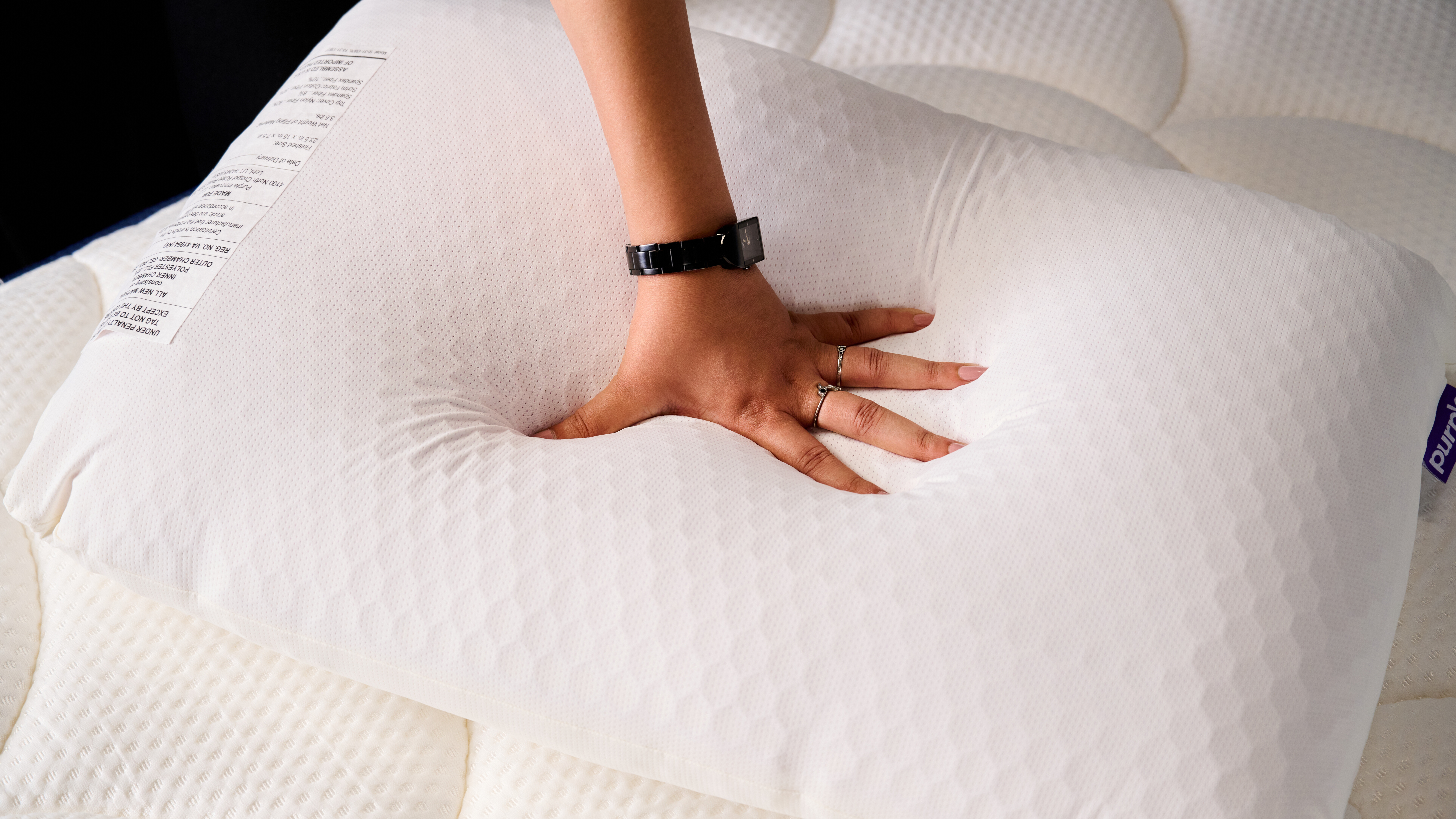 Hand placed on the surface of the Purple GridCloud pillow