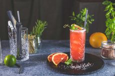 Pink grapefruit Mezcal Paloma cocktail on tray