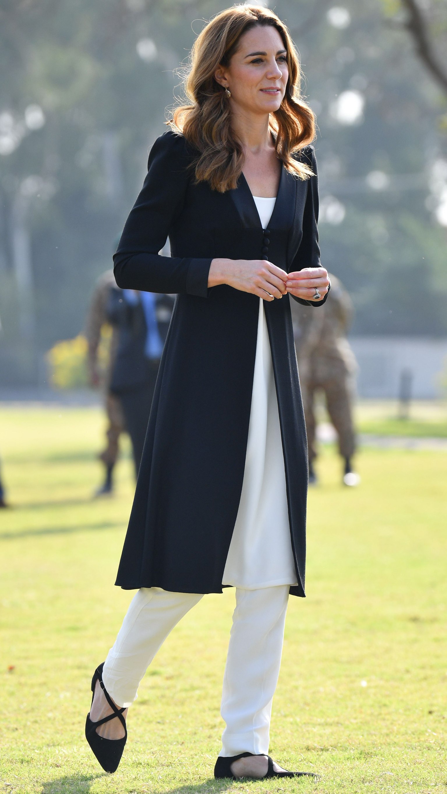 Catherine, Princess of Wales walks across the grass as she visits an Army Canine Centre in Pakistan on October 18, 2019