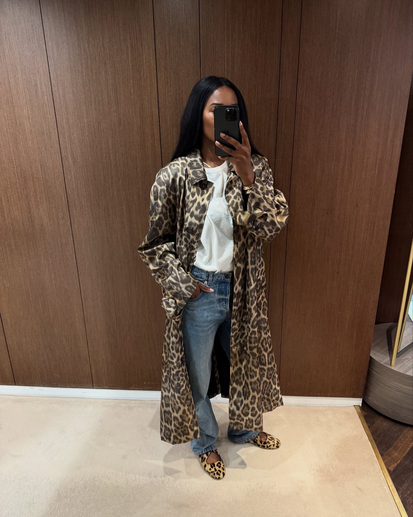 @nlmarilyn wearing a white T-shirt and jeans outfit with an animal print trench coat and ballet flats