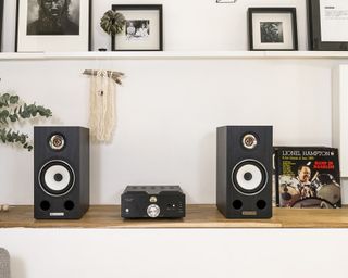 Triangle speakers on a sideboard