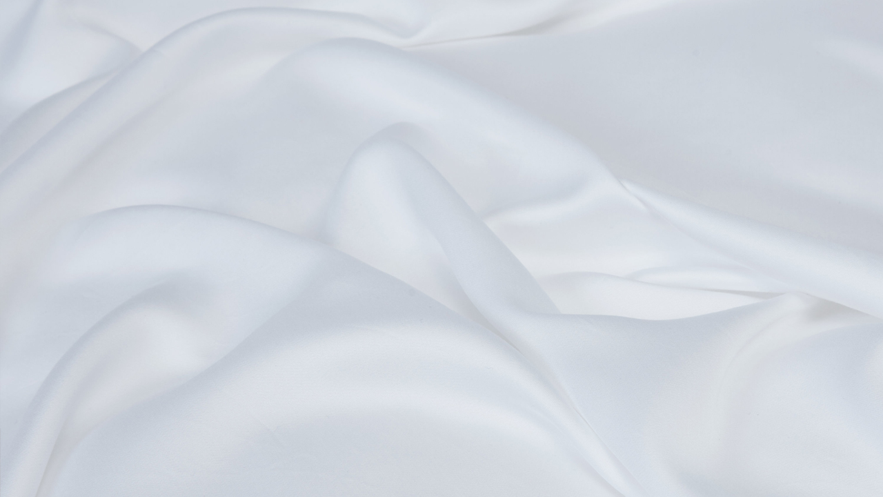 Close up of white bed sheets