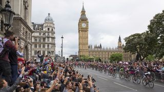 LONDON, ENGLAND - JULY 07: Crowds cheer as cyclists competing in the Tour de France, including stage winner Marcel Kittel (3rd R), pass through Parliament Square at the end of the race's third stage on July 7, 2014 in London, England. The first three stages of the Tour de France have taken place in England. After traveling through Yorkshire on the first two days, today's stage runs from Cambridge to London, finishing on The Mall. (Photo by Oli Scarff/Getty Images)
