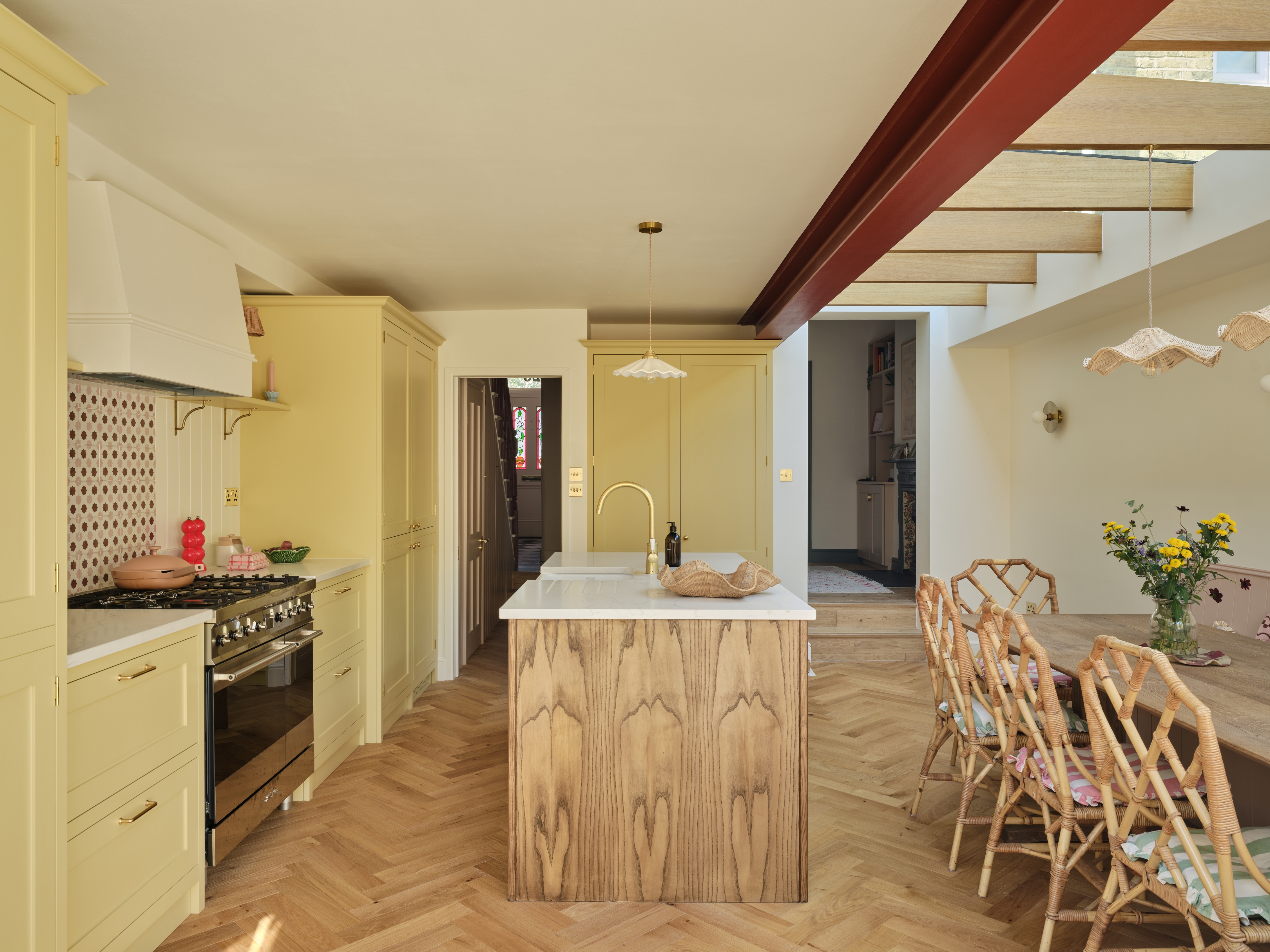 a yellow kitchen in a modern extension with a wood island with a detailed wood grain