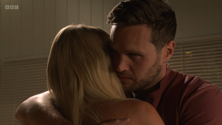 Keanu Taylor pulls a sinister look as he hugs Sharon Watts.