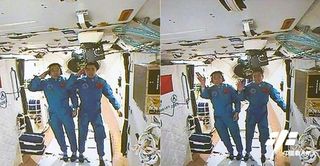 Astronauts Jing Haipeng and Chen Dong, the crew of China's Shenzhou-11 mission, salute and wave from inside the country's Tiangong-2 space laboratory after arriving at the mini space station on Oct. 18, 2016. The astronauts are flying a 30-day mission to the space lab, China's longest human spaceflight yet.