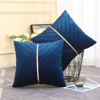 Two navy blue cushions placed on the floor