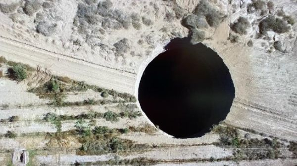 Overhead footage of the massive sinkhole, located in a rural area in Chile.
