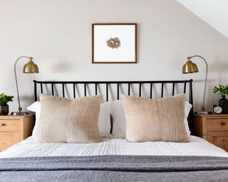 neutral bedroom with black framed bed