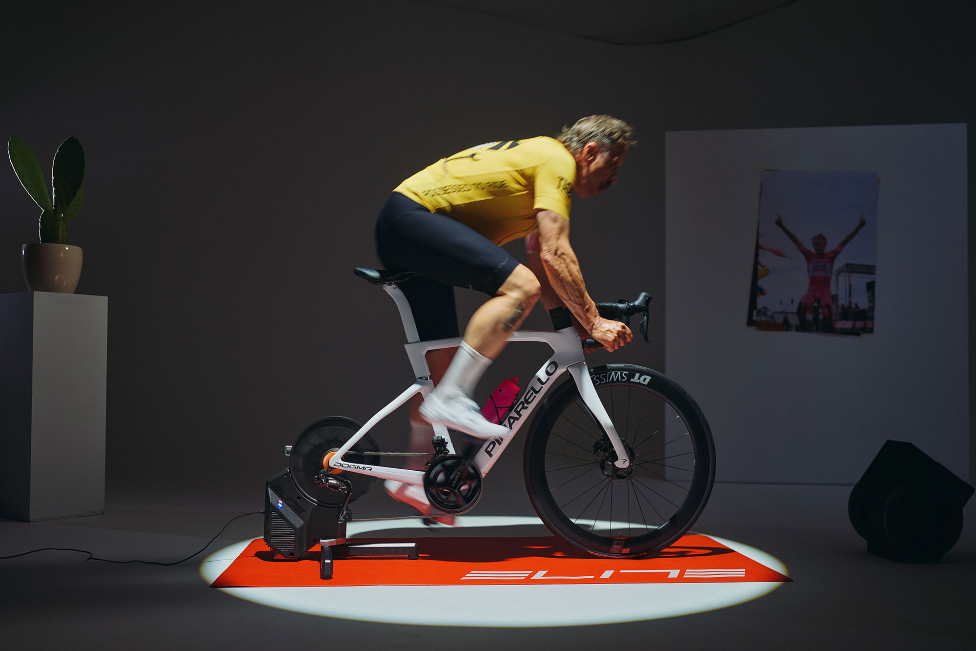 Elite Rivo with Zwift Cog and Click being ridden indoors by a man wearing a yellow jersey.