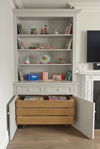 built in toy storage in a living room with roll out toy box