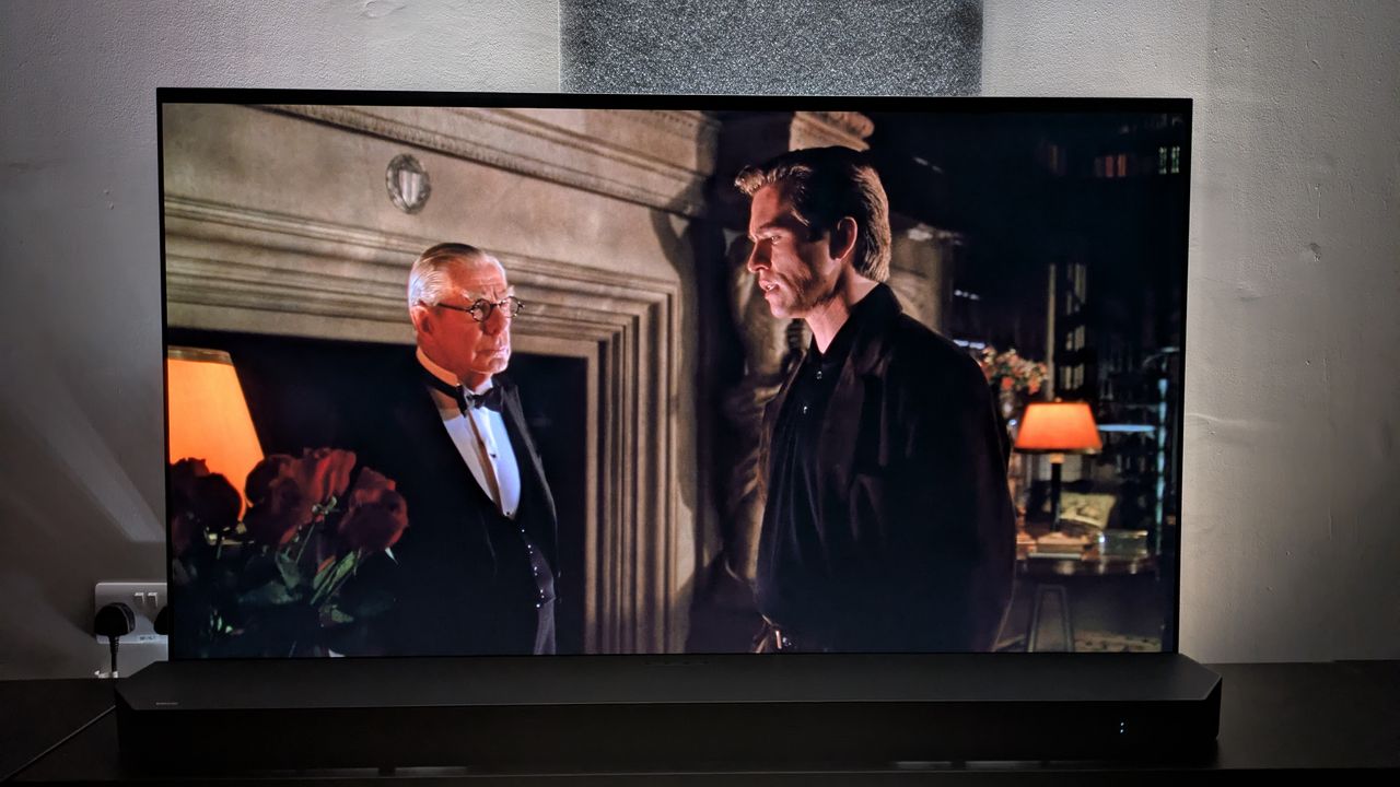 Batman Forever 4K Blu-ray showing Bruce and Alfred talking in a dark room on screen