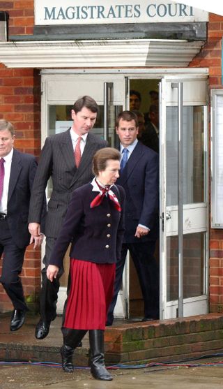 Princess Anne leaving court with her husband Tim Laurence and son Peter Phillips behind her