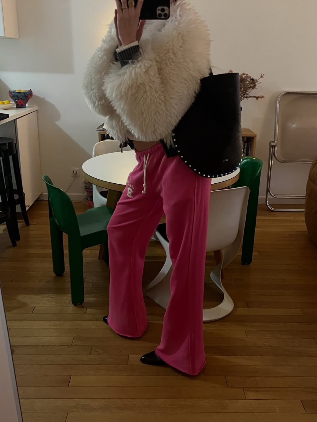 Laberiane Ponton wears pink track pants with a fluffy white jacket.