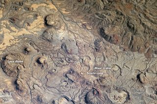 In this astronaut image of the Meidob Volcanic Field, you can see maar craters formed from explosive eruptions, lava domes from viscous flows and scoria cones formed around a single volcanic vent.