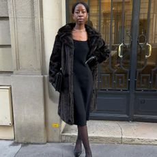 Sylvie Mus wearing a winter coat with gloves. 