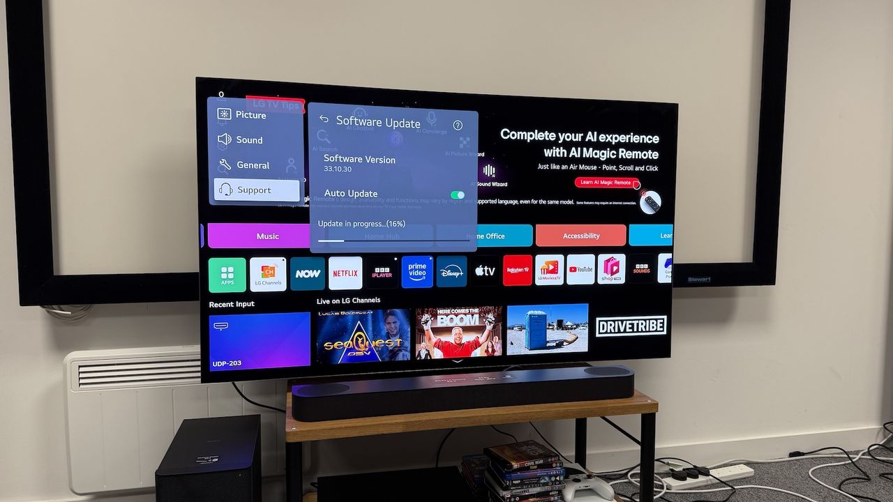 The 65-inch LG G5 OLED TV photographed on a wooden stand. ON the screen is the update window.