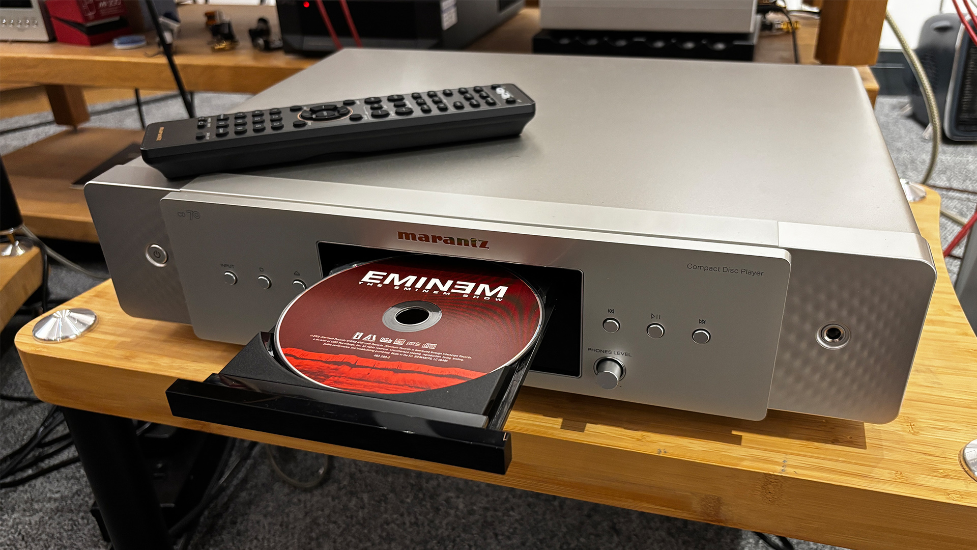 Marantz CD 70 CD player on wooden hi-fi rack with tray extended showing Eminem CD