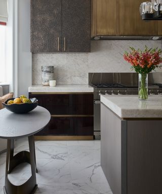 gray kitchen with burnished brass and marble