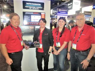 (L to R) In the NDI Central Pavilion at this year's NAB Show, Sam Provencher, Laura Gallagher, Megan Gustafson and Dan Gustafson from SportzCast demonstrated ScoreHub, designed to work with approximately 150 types of scoreboards across the U.S.