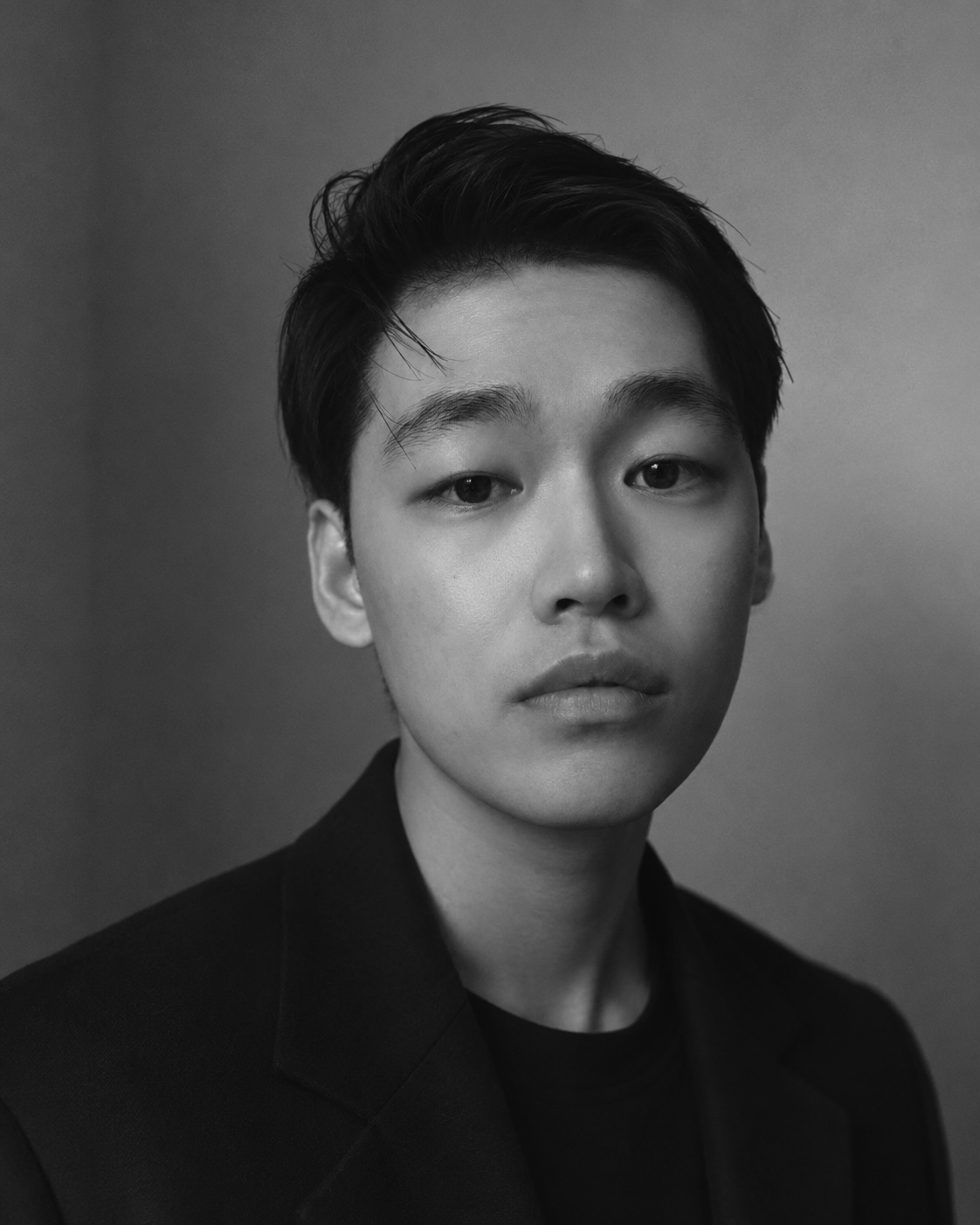 a black and white photo of a young asian man