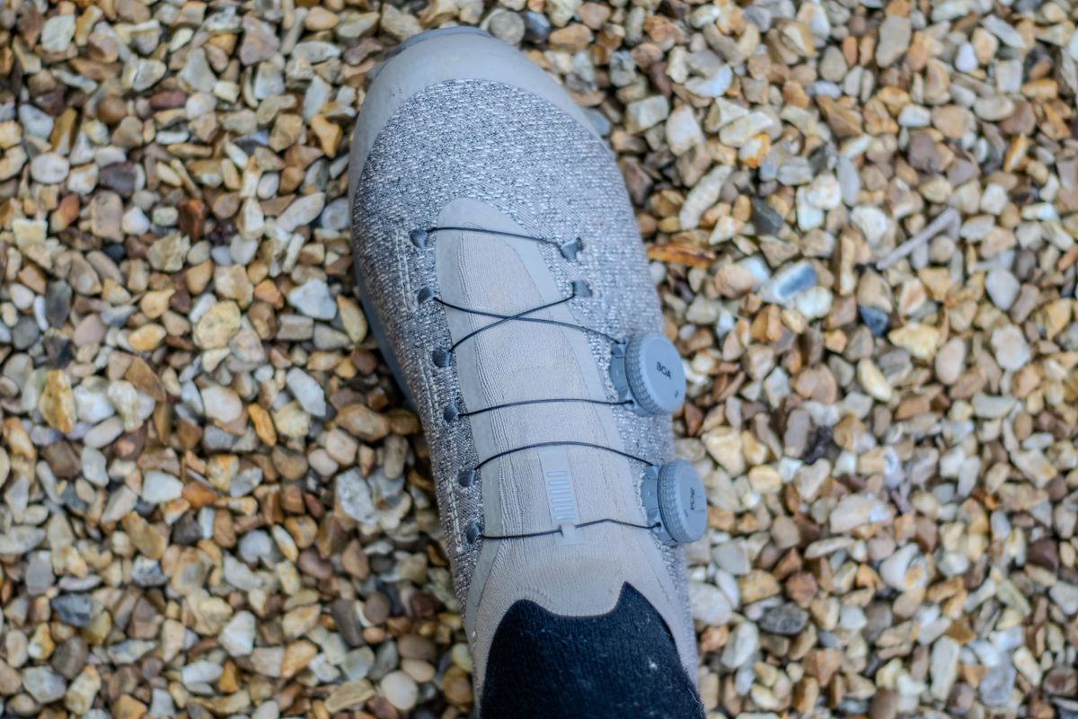A pair of Rapha Pro Team Gravel shoes on some gravel