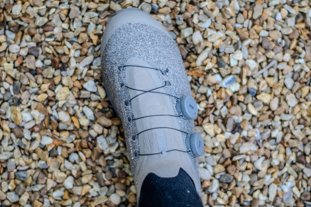 A pair of Rapha Pro Team Gravel shoes on some gravel