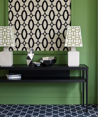 green painted hallway with black and white floor runner and wall hanging