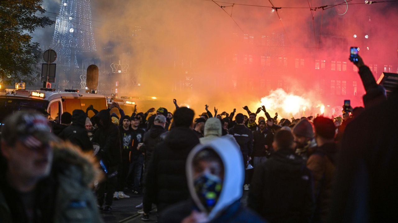 Fans of Maccabi Tel Aviv stage a pro-Israel demonstration at Amsterdam&#039;s Dam Square, lighting flares