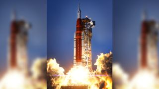 an orange rocket made of plastic bricks appears to be lifting off above a plume of smoke made from cotton balls